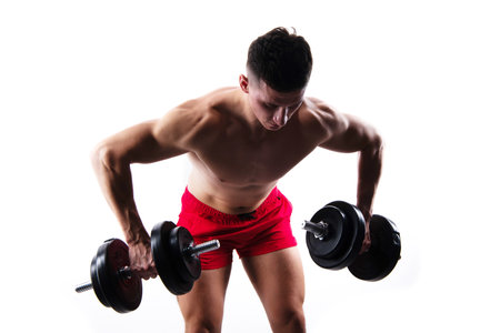 sport exercise in studio. sport man with barbells. biceps and triceps sport exercise.の写真素材