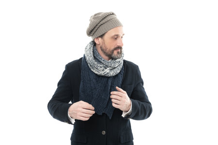 man winter fashion with warm clothes. studio shot of man wearing warm scarf and hat.