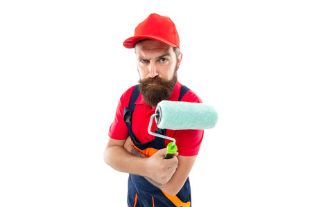 serious man painter with paintroller. man painter with paintroller in uniform. bearded man painterの写真素材