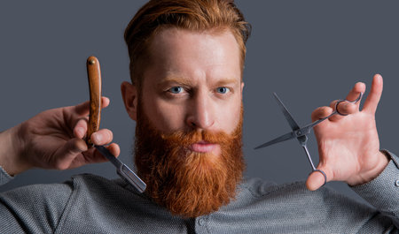 barber man hold scissors and blade at barbershop. concept of barbershop. man barber