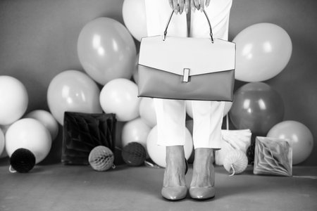 nice outfit. black friday shopping. female feet in shoes with bag. fashion accessory.の写真素材