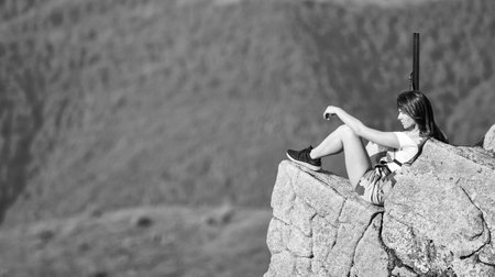 Military female. Observing point. Army forces. Brave girl dangerous situation. Fight for freedom. Sniper concept. Girl military warrior rifle. Woman military outfit hold weapon highlands backgroundの写真素材