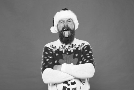 merry christmas. man in funny knitted sweater. xmas shopping time. prepare gifts and presents. happy bearded man in santa claus hat. new year party fun. celebrate winter holidays. Christmas timeの写真素材