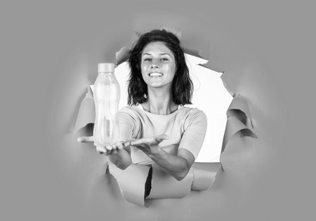 happy pretty woman with brunette hair hold botle of water, hydrationの写真素材