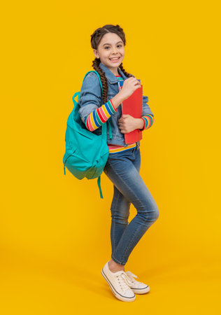 Happy schoolgirl. School education. Teenage girl holding books, education. Schooling and educationの写真素材