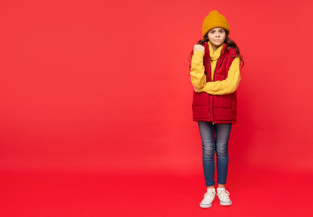 full length of child wearing warm clothes. express emotion. winter fashion. copy space.の写真素材