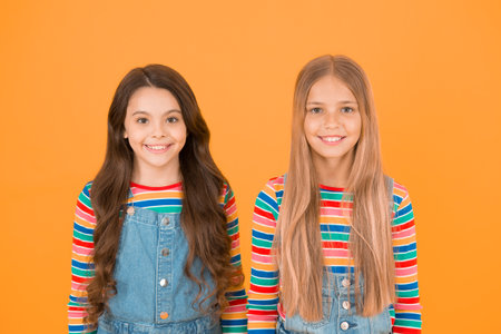 Long hair best female adorn. Girls blonde and brunette shiny healthy hair. Grow hair. Hairdresser salon. Kids beautiful friends or sisters with perfect hairstyles. Chevelure concept. Natural beautyの写真素材