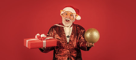 Being surprised. ready for xmas party. celebrate winter holiday. funny man wear santa claus coat and hat. shopping. Merry Christmas and Happy Holidays. New year is coming. happiness and joyの写真素材