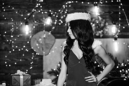 Christmas wish. Santa costume lingerie. Naughty new nice. Erotic surprise. Sexual holidays. Attractive girl erotic lingerie. Desirable Santa girl. Party for adults. Lingerie boutique. Merry christmasの写真素材