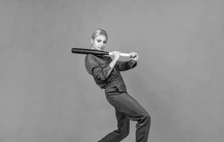 in motion. woman in boilersuit with bat. female baseball player. sports and games.の写真素材