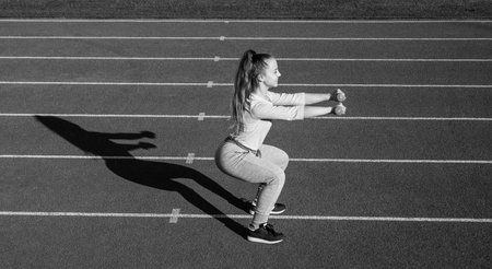 Make yourself stronger. Strong girl do dumbbell squats. Strength training. Strength training workoutの写真素材