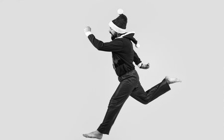 happy bearded guy in red santa claus costume running feel happiness about christmas shopping sales, xmasの写真素材