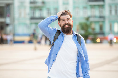 happy bearded guy is outside. portrait of guy with beard. brutal casual guy outdoorの写真素材