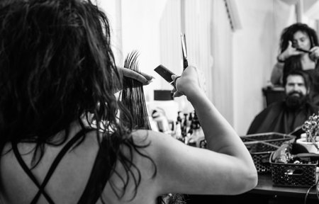 scissors and brush for hipster. male barber care. bearded man at hairdresser chair in salon. beauty and fashion. hair and beard styling. confident brutal guy with barbershop professional masterの写真素材