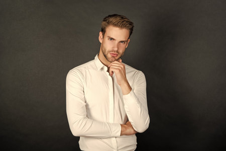 handsome businessman in shirt on black background, business