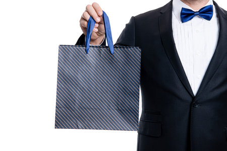closeup purchase of shopper man on shopping sale. tuxedo shopper man with shopping bagの写真素材