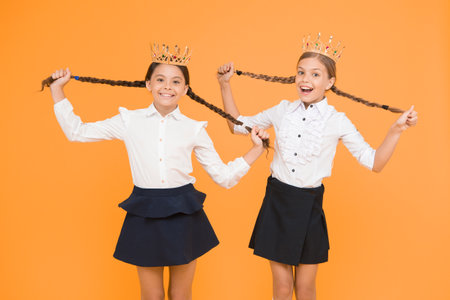 Award and respect. Cute princess. Motivational award for school children. Girls kids imaging luxury lifestyle. Award coronation. Brilliant pupils. Schoolgirls wear golden crowns symbol of respectの写真素材