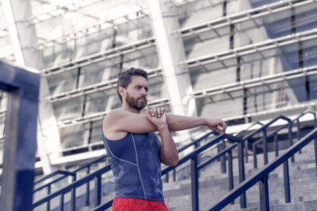 Man stretching. Keeping those muscles flexible. Training on fresh air. Warming up his muscles. stretching for a workout routine. Sweat now and smile later. Remain flexibleの写真素材