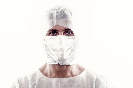 man doctor epidemiologist wearing respirator mask and safety protective costume during creating vaccive from coronavirus pandemic outbreak isolated on white, covid 19の写真素材