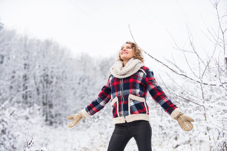 best place to feel freedom. woman enjoy winter landscape of snowy forest. female winter fashion....