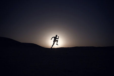 silhouette or man runner, guy running outdoor at clear skyの写真素材