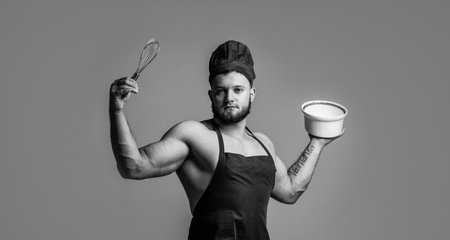 Lifestyle addiction. sexy man with body muscles in cook apron. professional handsome chef cooking in kitchen. culinary and cuisine. muscular man use utensils. guy eating healthy. food for athletesの写真素材