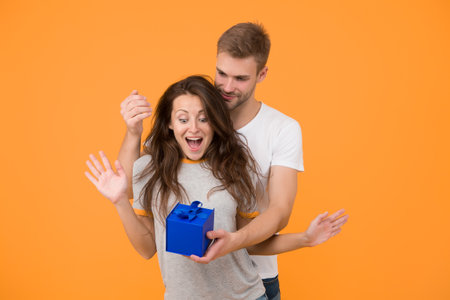 Make her wow. Surprised woman got present from man. Birthday surprise. Couple in love. Surprise box. Surprise gift. Present and souvenir. Gift shop. Gifting surprise. Happy Valentines dayの写真素材