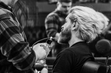 Personal hygiene. confident and handsome brutal man. grooming hair in barbershop.の写真素材