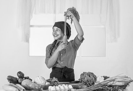 girl holds carrot which is good for teeth and eyesight, healthの写真素材