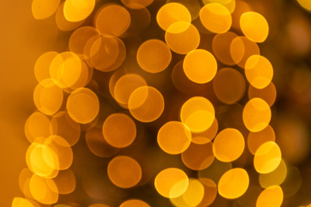 bright abstract bokeh background. blurred background with no people. bokeh gold color backgroundの写真素材