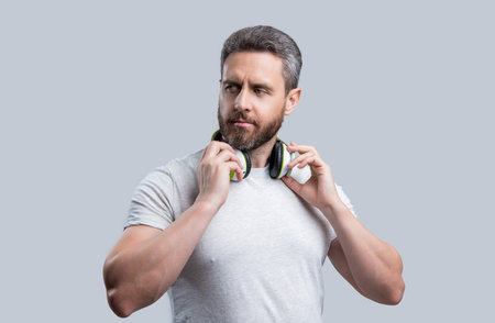 handsome man listening music in headphones at studio. man listening music in modern headphone