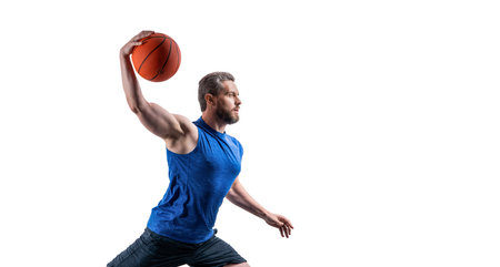muscular sportsman play dunk basketball in studio. professional sportsman play basketballの写真素材
