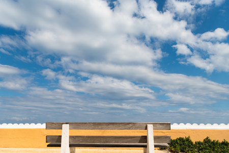 empty wood bench with view on cloudy skyの写真素材