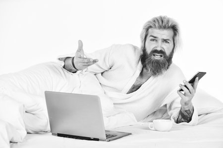 too much work. Project Manager Finishing Work in Bed. Man working on laptop and phone in bed. Male spending time in room using pc. relax lifestyle concept. Man in Bed Working on Computer at Nightの写真素材