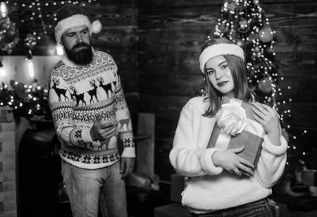 celebrate new year together. selective focus. merry christmas. love is in the air. family holiday weekend. lovers at decorated tree. winter season shopping sales. happy santa couple in loveの写真素材