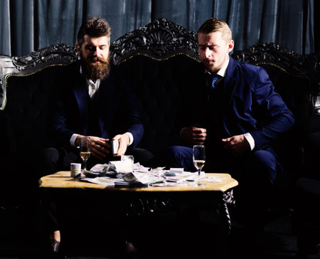 Illegal deal concept. Men in suit, businessmen sitの写真素材