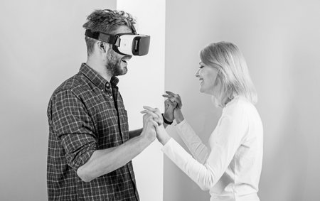 Man VR glasses enjoy video game. Best gift ever. Man enjoy virtual reality. Girl happy he like her...