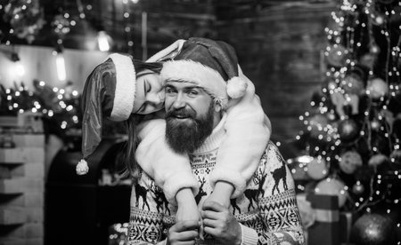 Festive spirit. Lovely married couple cuddle christmas tree background. Cheerful mood. Christmas is time for giving. Couple in love enjoy christmas holiday celebration. Happy new year. Guess whoの写真素材