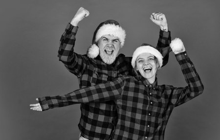 Good mood. Couple goals. Santa Claus style. Christmas time. Man and woman christmas holiday celebration. Family shopping. Christmas party. Ideas for fun. Winter joy. Couple in love cuddlingの写真素材