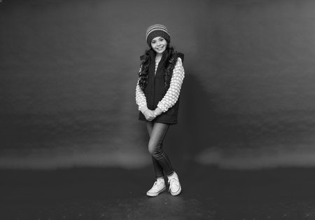 full length of child wearing warm clothes. express positive emotion. winter fashion.の写真素材
