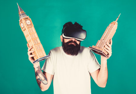 Man on confused face study architecture or design in virtual reality. Guy in VR glasses holds Big...