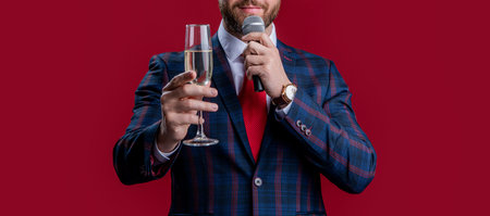 presenter cheering and hold microphone isolated on red background. presenter celebrate eventの写真素材