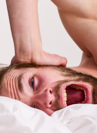 Morning routine tips to feel good all day. Man handsome guy lay in bed in morning. Tips on how to...