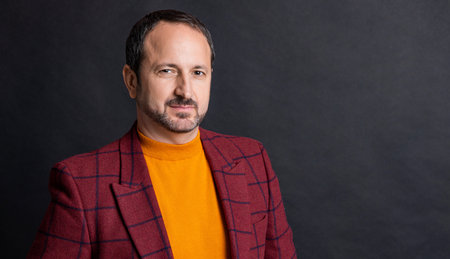 mature man in stylish menswear in studio with copy space. menswear for mature man.