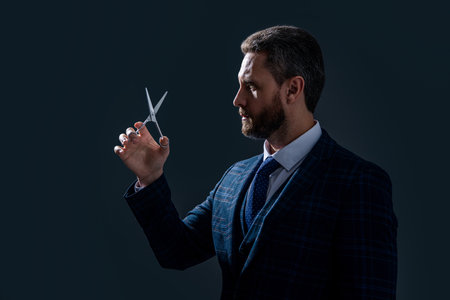 hairsdresser man with scissors, copy space. man with scissors in hairsdresser studio.