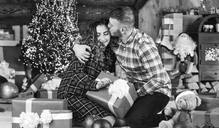 Happy woman and man. Holiday gift. Holiday mood. Couple in love making surprise for each other. Family time. Happiness and joy. Best holiday. Christmas time. Celebrate new year at home. Spread loveの写真素材