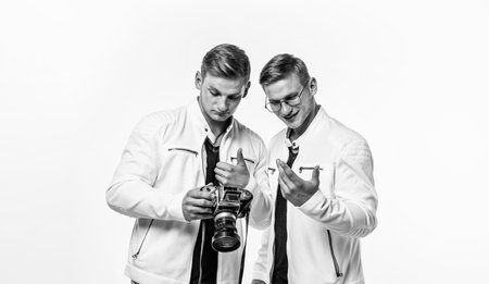 twin brothers men look alike use vintage photo camera, photographingの写真素材