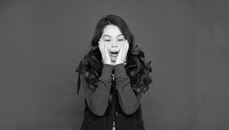 portrait of child wearing warm clothes. express emotion. winter fashion. amazed sleepy kid