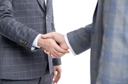 two hands dealing business partnership. partnership of business men handshaking isolated on whiteの写真素材