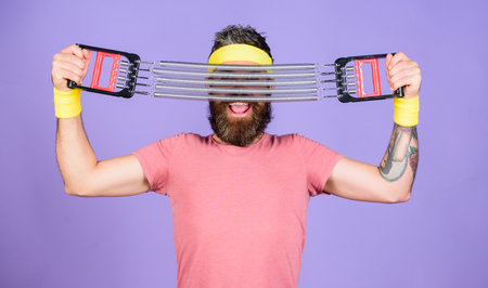 Man bearded athlete exercising with expander equipment. Join my sport class. Sportsman wear retro...